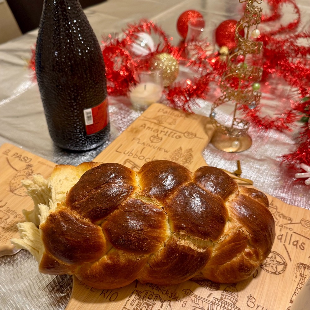 braided challah loaf on a festive holiday table
