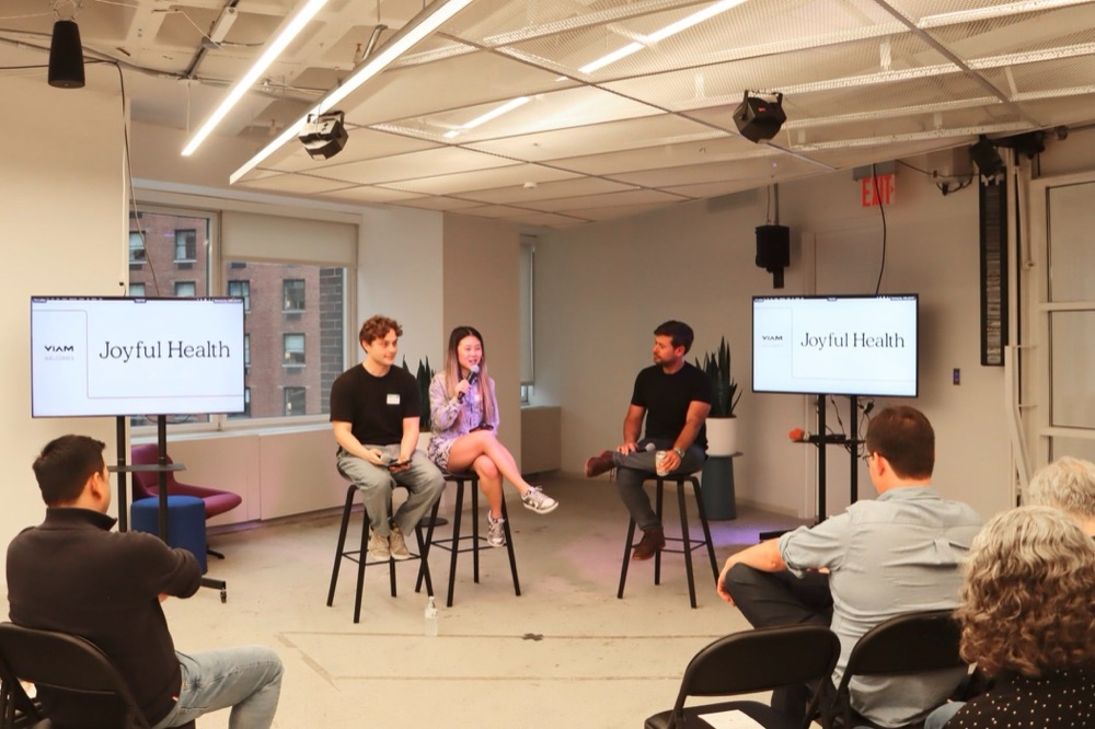 three panelists on stools at a joyful health talk