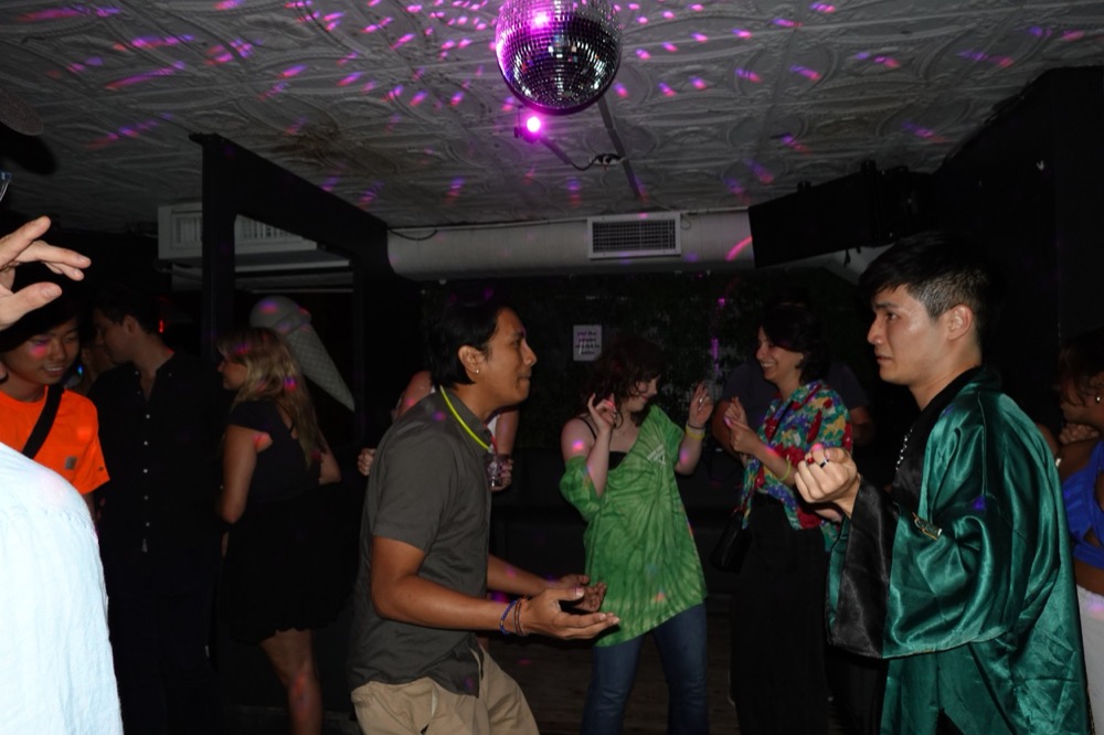 friends dancing under a disco ball