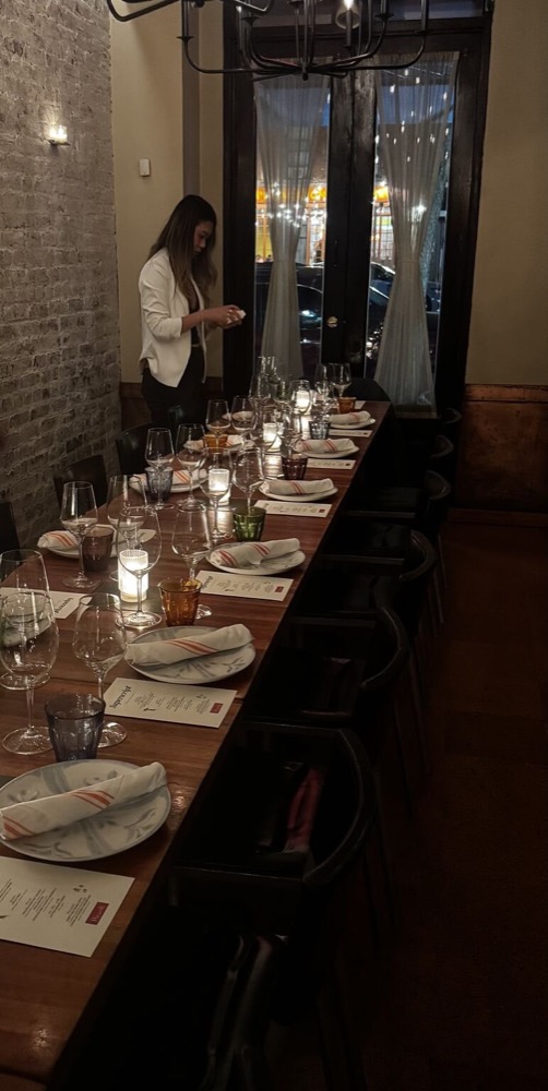 long candlelit dinner table set in a restaurant