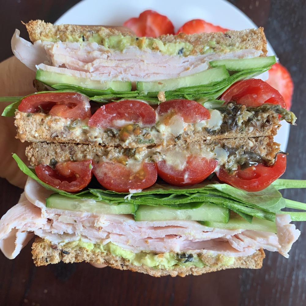turkey sandwich with tomato, cucumber, and spinach
