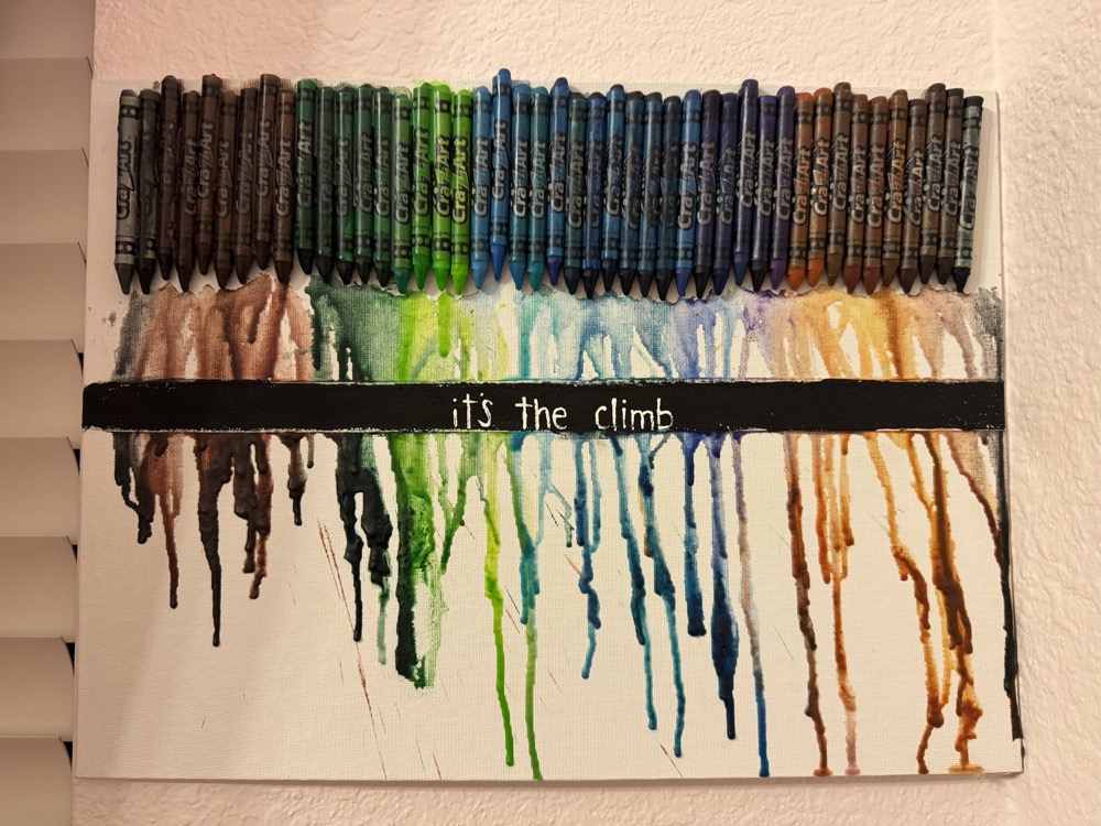 melted crayon canvas with the words "it's the climb"