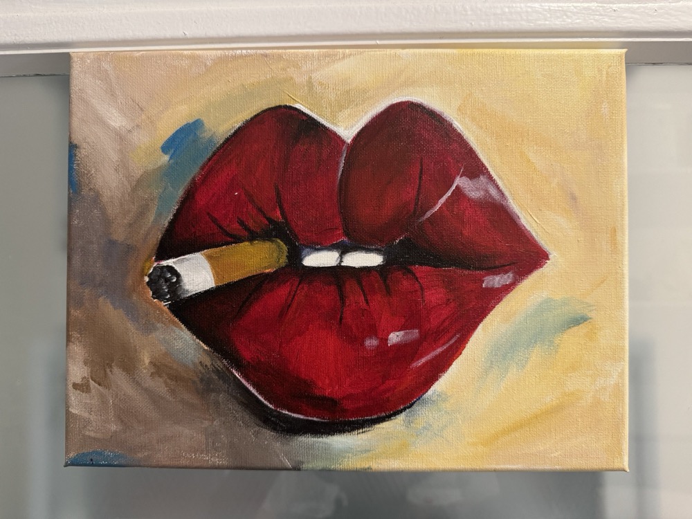 painting of red lips holding a cigarette