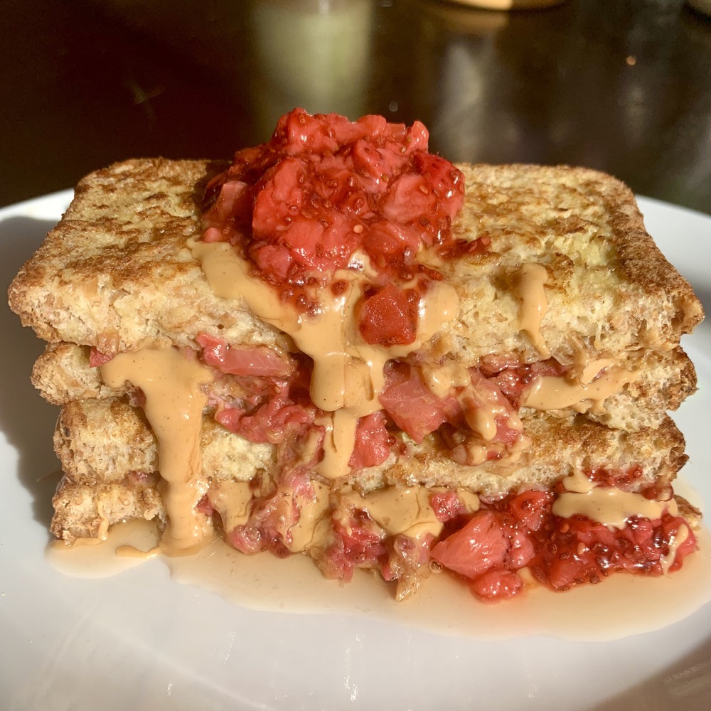 toast layered with strawberry compote and peanut butter