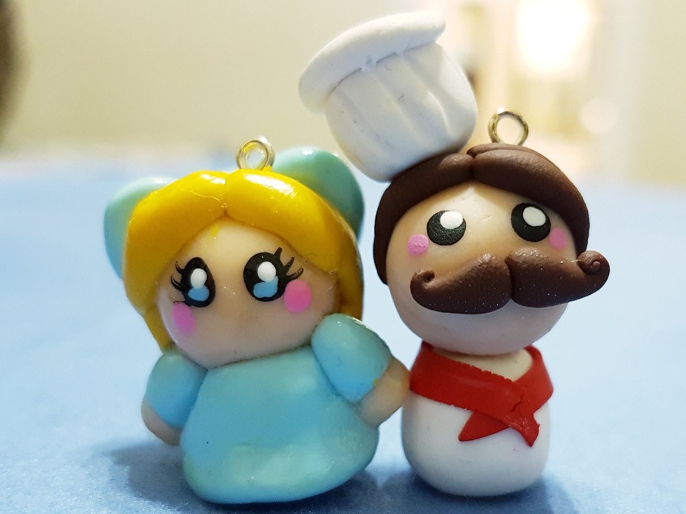 two clay chibi charms, a fairy and a mustachioed chef