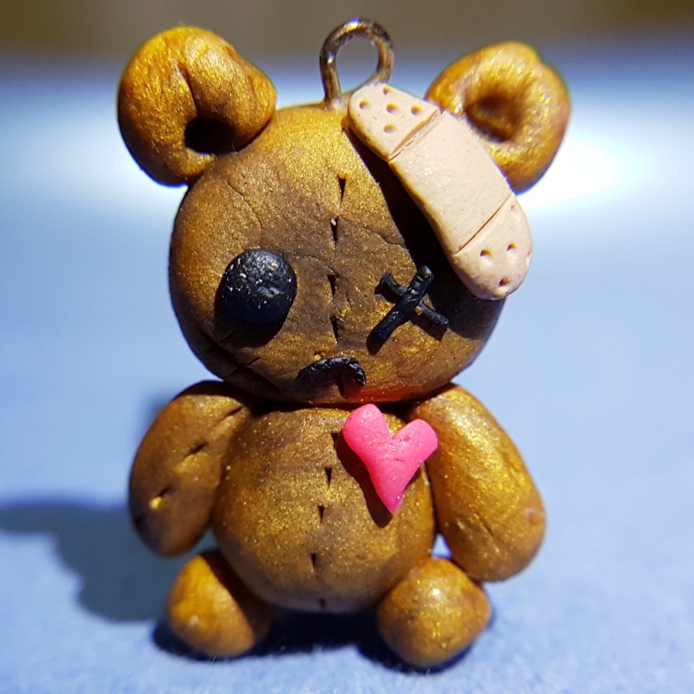 clay teddy bear charm with bandage and pink heart